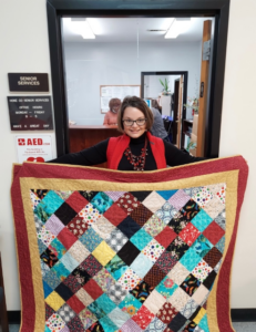 Mary Hollingsworth holds quilt